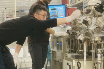 scientists using materials testing machine