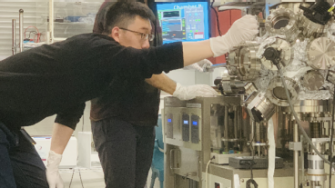 scientists using materials testing machine