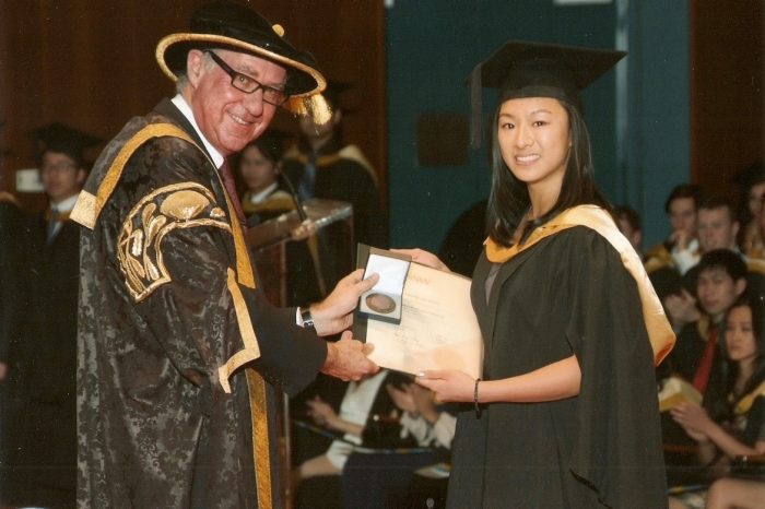 Student receiving medal/award from Gonski