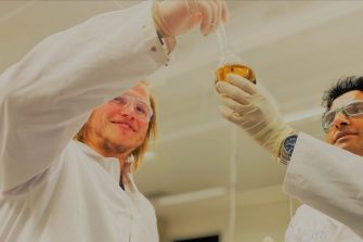 two scientists with flask