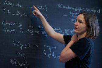 Woman doing maths on chalk board