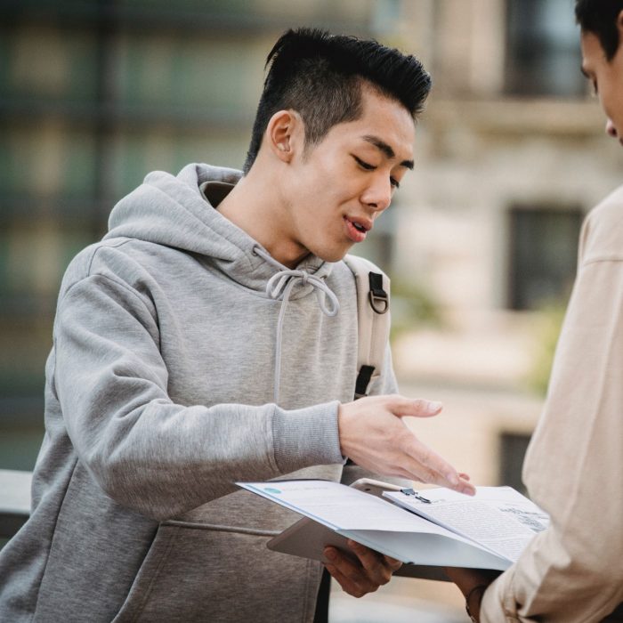 Young man helping another man