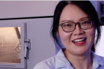 A physics student smiling at the camera