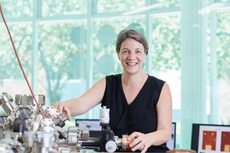 Physics professor standing with equipment