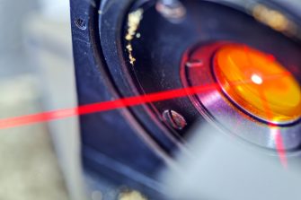 Red laser on optical table in physics laboratory