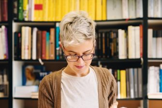 Woman with bookshelves behind her