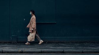 Person walking masked and alone