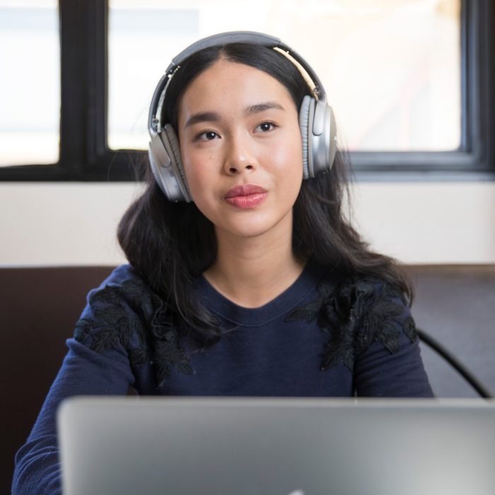 Student studying with headphones and laptop