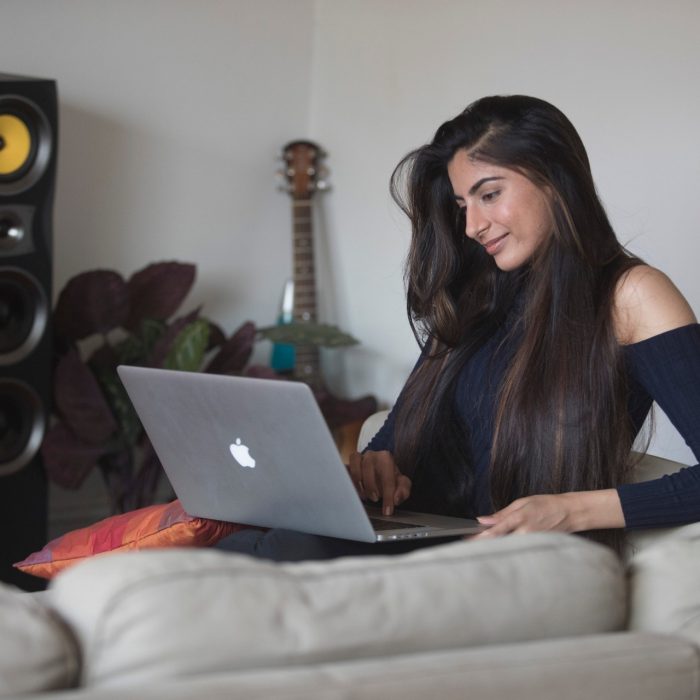 Student sudying on couch with laptop