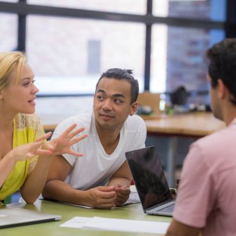 Students at desk talking