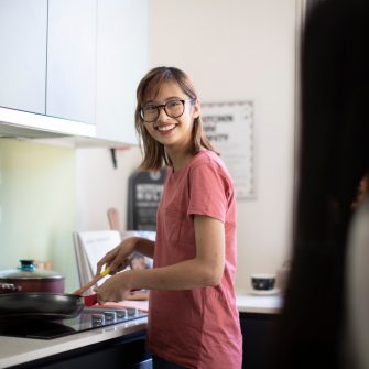 Students cooking in kitchen of student accommodation
