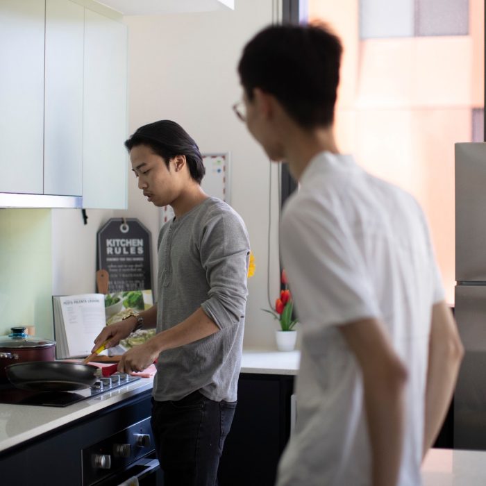 Students cooking in kitchen of student accommodation