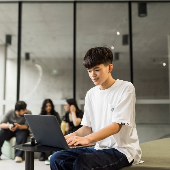 Student studying with laptop in the Student Hub at L5