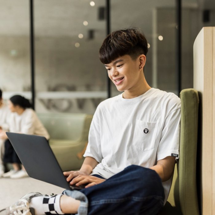 Student Tyson studying in the Student Hub at L5 on laptop