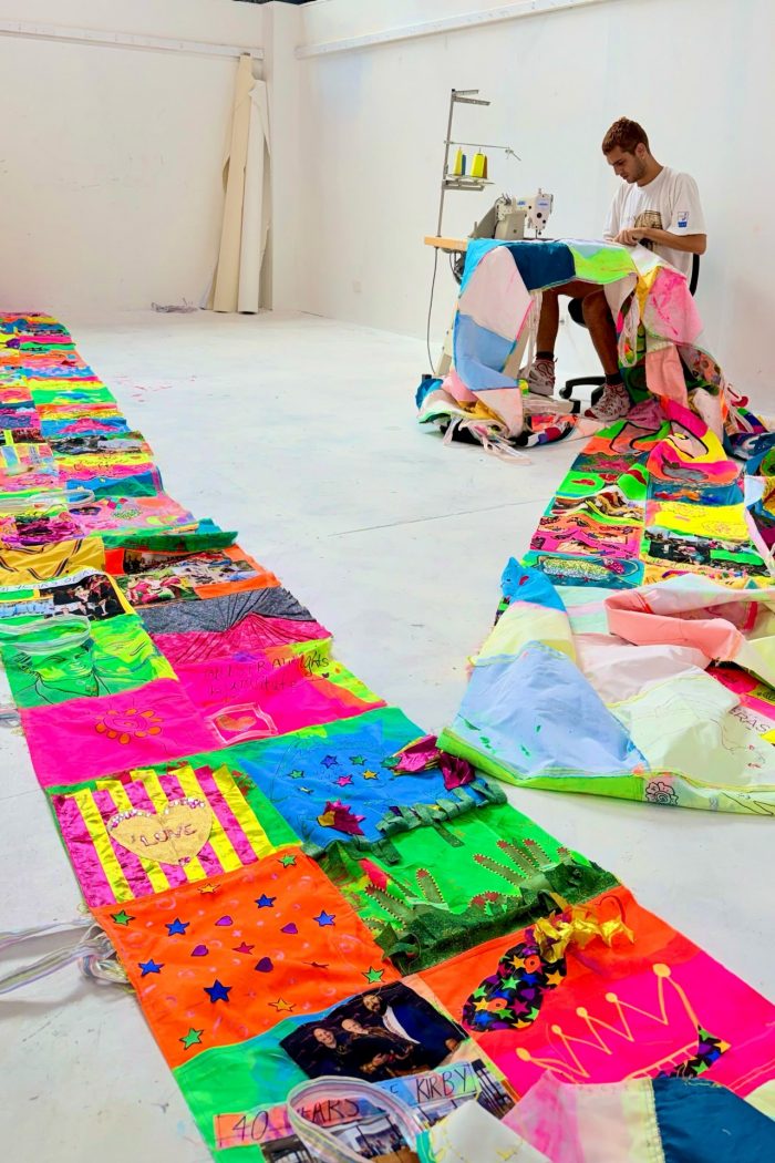 Artist and UNSW alum Jordan Gogos sewing the UNSW Queer Community Quilt.