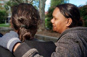 Indigenous woman comforting another