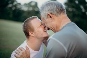 father and son face to face smiling  