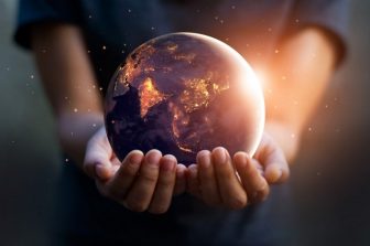 Photo of hands holding globe