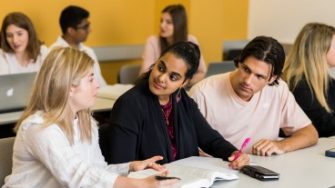 Photo of students partnering with each other on a project