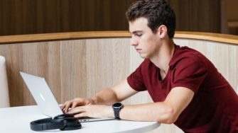 Photo of student using laptop on campus