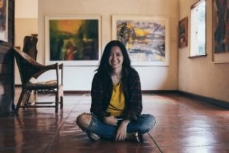 Photo of person sitting on floor