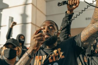 Man in black crew neck t-shirt holding microphone