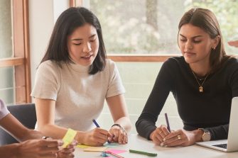 Student and career mentors talking in a meeting room at UNSW.