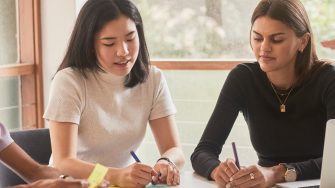 Student and career mentors talking in a meeting room at UNSW.