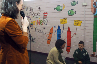 Dr Georgie Fleming stands behind a one-way mirror to coach a parent interacting with her child. Photo: UNSW