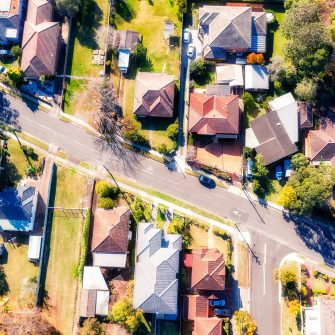 Aerial view of housing in the suburbs divided by a road