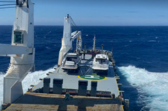 Cargo ship at sea, rolling in a big swell
