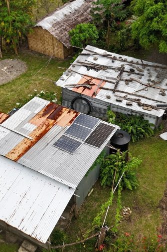 A composite photo of repairing an off-grid solar device