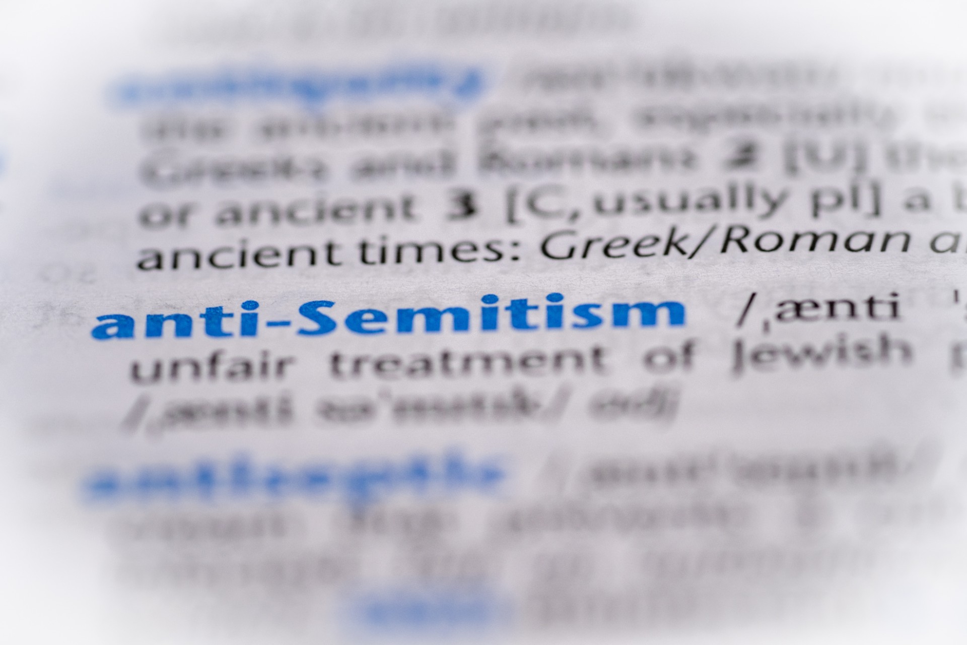 Anti Semitism word in a dictionary. Selective focus, close up.