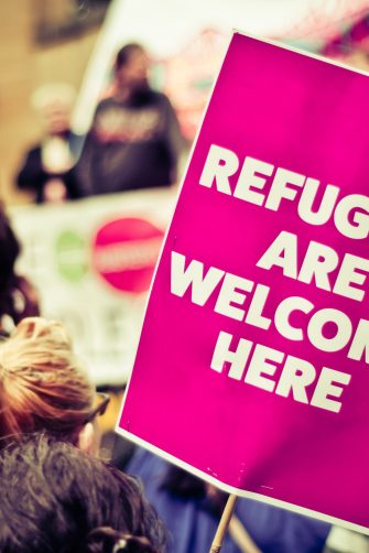 Busy Street Protest March With A Sign Saying Refugees Are Welcome Heren