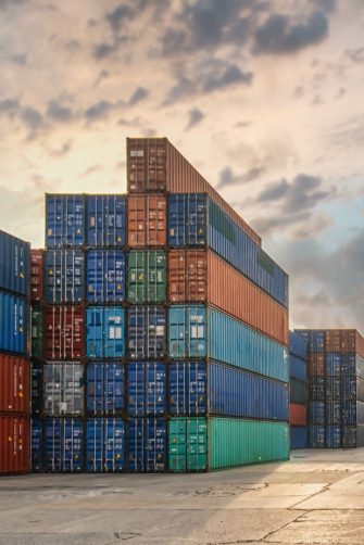 perspective view of containers at containers yard with forklift and truck