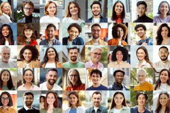 Young professional businesswoman holding her laptop outside while walking near modern business center. Business lifestyle concept