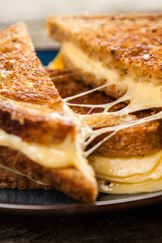 Grilled cheese sandwich on old wooden table