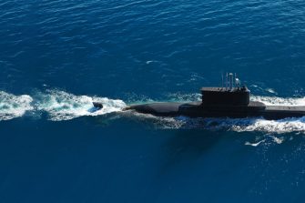 Aerial of a submarine moving through the sea
