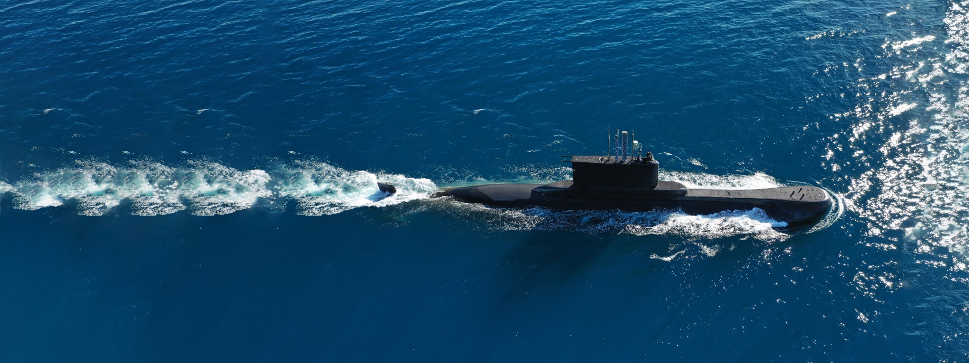Aerial of a submarine moving through the sea