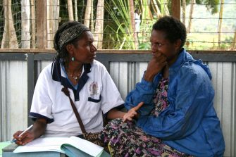 Research nurse explains study procedures, Papua New Guinea. 