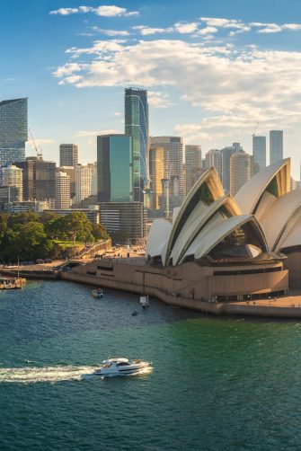 Scientia Professor Richard Holden and Professor Brian Schmidt on sit on a couch on stage at the National Press Club