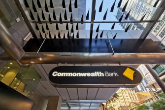 BRISBANE, AUSTRALIA - MAY 19, 2020: Banner of Commonwealth Bank of Australia (CBA) flagship headquarters office in Brisbane Central Business District on Queen Street. There are people standing on the street.