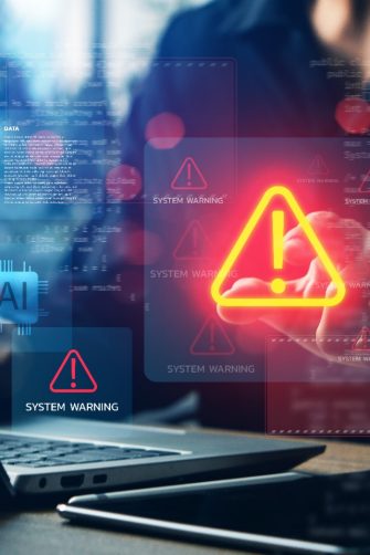 Cybersecurity system warning alert on laptop with AI and data icons, concept of artificial intelligence risks, data breach, malware attack, digital security, and technology protection.