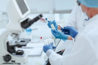 Pharmacists discussing a new drug in the laboratory .