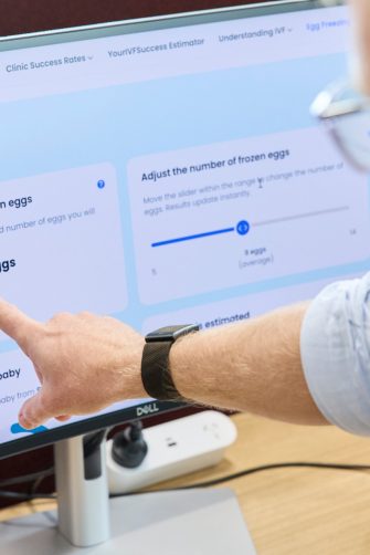 A man pointing to a computer screen.