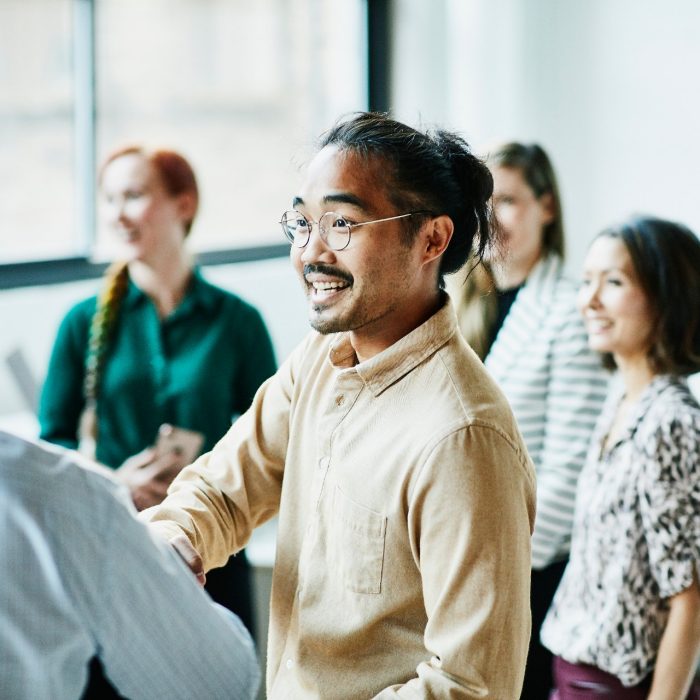 Businessman shaking hands with colleague after meeting in office