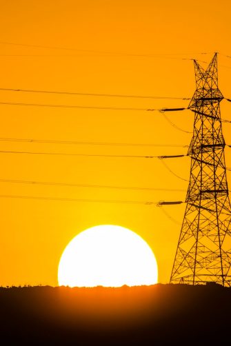 Power transmission tower and its power cables installed over a hill in a village near Panvel, Navi Mumbai.
