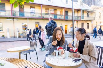 Happy Asian woman friends having lunch at outdoor restaurant during shopping together in the city. Attractive girl enjoy and fun urban outdoor activity lifestyle travel city street on holiday vacation