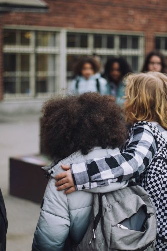 Primary students walk arm in arm to school