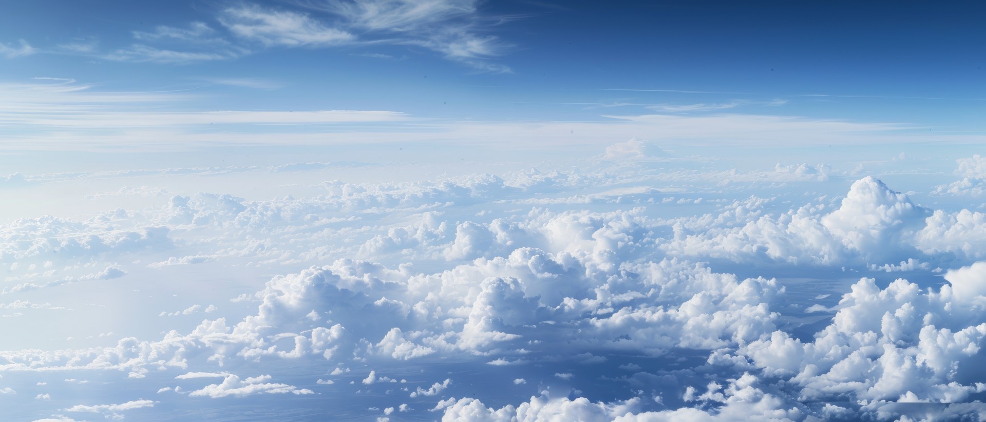 A photo of the sky taken from an airplane, showing white clouds and blue skies. The perspective is from above looking down at vast cloud formations stretching to infinity, 8k resolution, Nikon --ar 7:3 --style raw --stylize 0 Job ID: 052cface-820b-4e8a-956b-d725ea667647 AdobeStock_836439082